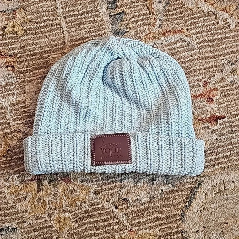 Love your melon baby blue and white beanie and brown leather patch
